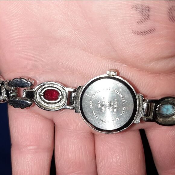 Accutime silver watch w diff stones set in it.